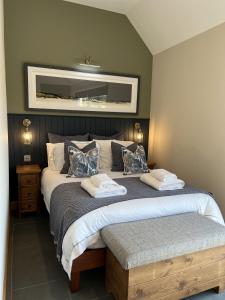 a bedroom with two beds and a mirror on the wall at Raasay Studio Lodge in Arisaig