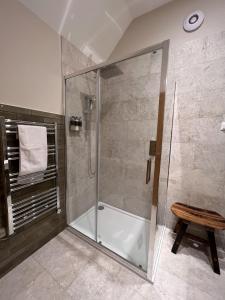 a shower with a glass door in a bathroom at Raasay Studio Lodge in Arisaig