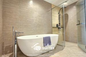 a bathroom with a tub and a glass shower at Expressionz Premium Suites @ KLCC in Kuala Lumpur