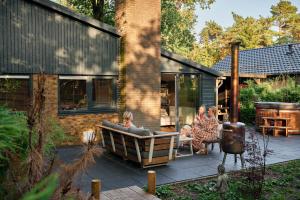 a group of people sitting on a patio at ZEN-bungalow no 6 met sauna en hottub in Rheezerveen