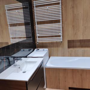 łazienka z 2 umywalkami i 2 oknami w obiekcie Apartament Perła Kutna w Kutnie