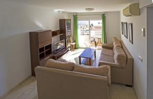 salon z 2 kanapami i stołem w obiekcie Apartamentos Turísticos Fercomar w mieście Nerja