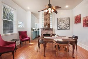 a dining room with a ceiling fan and a table and chairs at Redstick Cottage in Baton Rouge