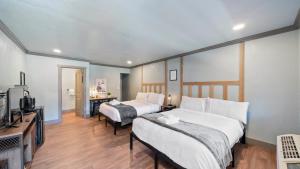 a hotel room with two beds and a television at Blue Jay Lodge in South Lake Tahoe