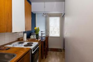 a kitchen with a stove and a sink in it at Hot spot of Vaasa, large balcony, City Hall views in Vaasa +3 photos