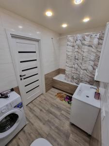 a bathroom with a washing machine and a shower at Яровиця 2 кімнати in Lutsk