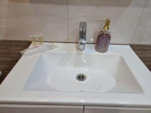 a white sink with a bottle on top of it at Яровиця 2 кімнати in Lutsk