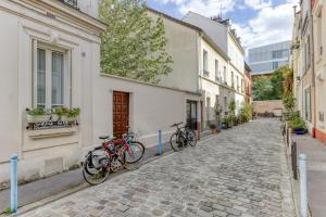 two bikes parked on the side of a street at Countryside in Paris 14 - Lovely and Calm 1bd Flat in Paris
