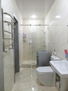 a bathroom with a shower and a toilet and a sink at APARTMENT - КВАРТИРА NEW in Tashkent