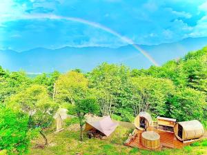 a rainbow in the sky over a group of tents at Starry Sky and Sea of Clouds Hotel Terrace Resort - Vacation STAY 75148v in Takeda