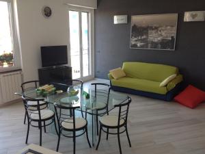 a living room with a table and chairs and a couch at Best Lavagna Apartment in Lavagna