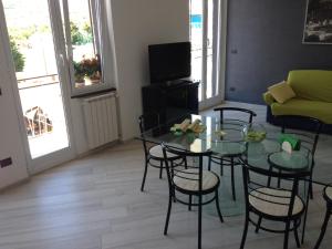 a living room with a table and chairs and a couch at Best Lavagna Apartment in Lavagna