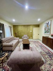 a large living room with a couch and a table at The Khayabaan - Luxurious Home Stay Away From Home in Srinagar