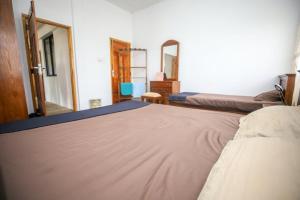 a bedroom with a large bed and two mirrors at Donkey clinic and education center in Mannar