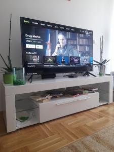 a flat screen tv sitting on a white entertainment center at Apartman Mančić in Pirot