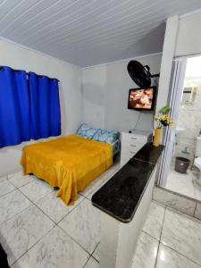 a bedroom with a bed and a television in it at Apartamentos SOLAR PALMER in Cabo Frio