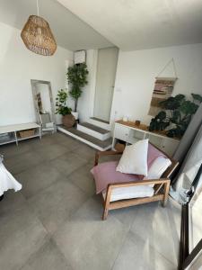 a living room with a couch and a potted plant at MEDITERRANEAN HOUSE - Habitaciones Privadas en Casa Compartida in Mairena del Aljarafe