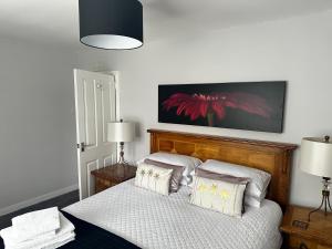 a bedroom with a bed with white sheets and pillows at The Sandgate New Immaculate 1-Bed Apartment in Ayr in Ayr