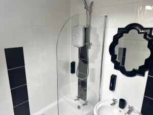 a bathroom with a shower and a sink and a mirror at 1 Bed Flat - Sleeps 2 - Parking - Wifi in Ayr +9 photos