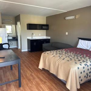 a hotel room with a bed and a kitchen at Econo Lodge in Danville