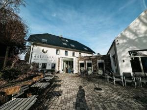 a building with chairs and a patio in front of it at Hotel Restaurant Auerhahn in Bad Wildbad