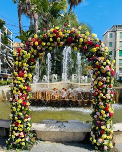 a large arch with flowers and a fountain at Nuovissimo trilocale in centro : Ca’ Del Mar in Sanremo