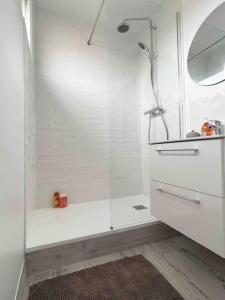 bagno bianco con doccia e lavandino di Nice sunny apartment of 70m2 a Montrouge