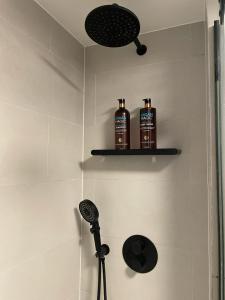 a bathroom with two bottles ofodorizers on a shelf at Tanya's Place-Stylish flat in Marylebone in London