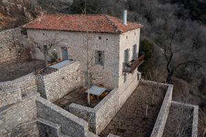 an aerial view of a stone house on a mountain at Moreas Peak Lodge in Magoúliana