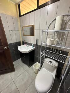 a bathroom with a toilet and a sink at Hope Garden in Sarapiquí