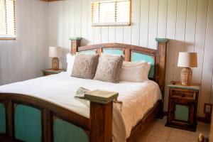 ein Schlafzimmer mit einem Holzbett mit Kissen und Lampen in der Unterkunft Lands End - 267 Ridge Lane in Branson