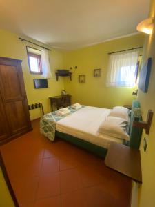 Postel nebo postele na pokoji v ubytování Notti Etrusche a Sovana