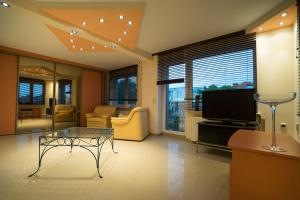 a living room with a glass table and a television at Willa Promenada in Jastarnia