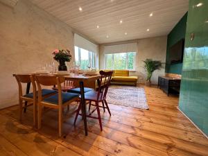 a dining room with a table and chairs and a couch at Magical two bedroom apartment in Viljandi in Viljandi