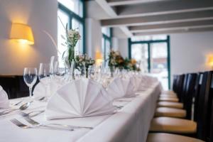 a long table with glasses and napkins on it at Hotel Restaurant Auerhahn in Bad Wildbad