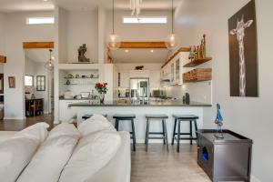 a living room with a white couch and a kitchen at Malibu Retreat with Balcony and Mountain Views in Malibu