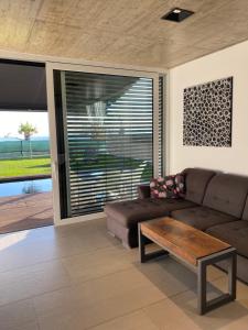 a living room with a couch and a coffee table at VOO residence in Malečnik