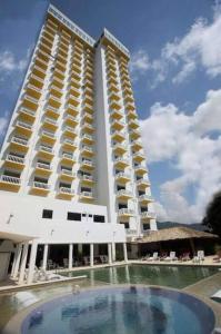 um grande edifício com uma piscina em frente em Luxurious Apartment, Oceanfront, spectacular view em Acapulco