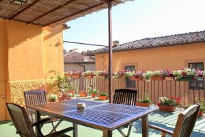 a wooden table and chairs on a patio at La Terrazza Di Montepulciano in Montepulciano