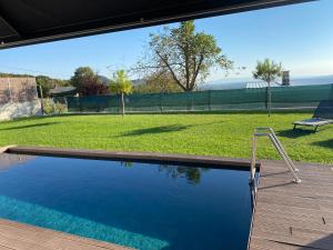 a swimming pool with a swing in a yard at VOO residence in Malečnik