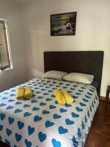 a bedroom with a bed with blue hearts on it at Apartmani Zelenika in Herceg-Novi