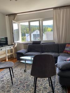 a living room with a couch and a table at Am Birkenhain in Titisee-Neustadt