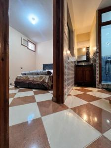 uma grande sala com piso em xadrez e um quarto em Dar Bennis em Rabat