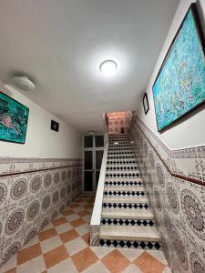 a staircase in a room with a tile floor at Dar Bennis in Rabat