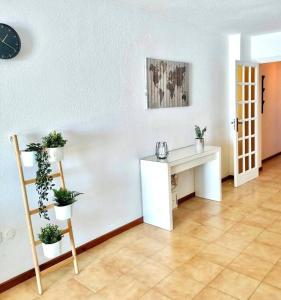 a room with a white desk and potted plants at Ocean view apartment with terrace in Radazul