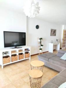 - un salon avec un canapé et une télévision dans l'établissement Apartamento vistas al océano, à Radazul