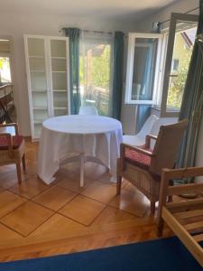 a living room with a white table and chairs at Am Birkenhain in Titisee-Neustadt