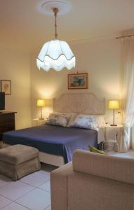 a bedroom with a bed and a chandelier at B&B Massico Apartments in Sant'Agnello