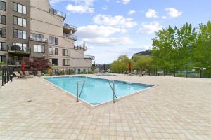 a swimming pool in front of a building at Legacy On Mara Lake- Unit 608 in Sicamous