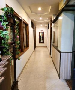 a long hallway with plants on the walls at Hotel Royal Brooks in Chandīgarh